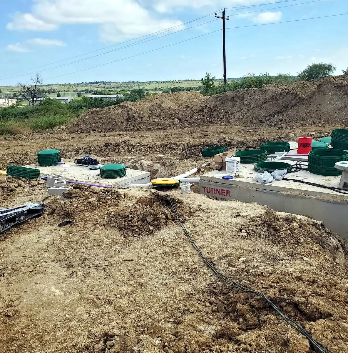New septic tanks set in a row before backfill